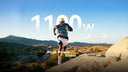A trail runner jumping over rocks with an Ascentiz H Ultra exoskeleton featuring 1100W peak power boost.