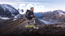 A man hiking in the mountains with an Ascentiz exoskeleton featuring 50km dual-battery range.