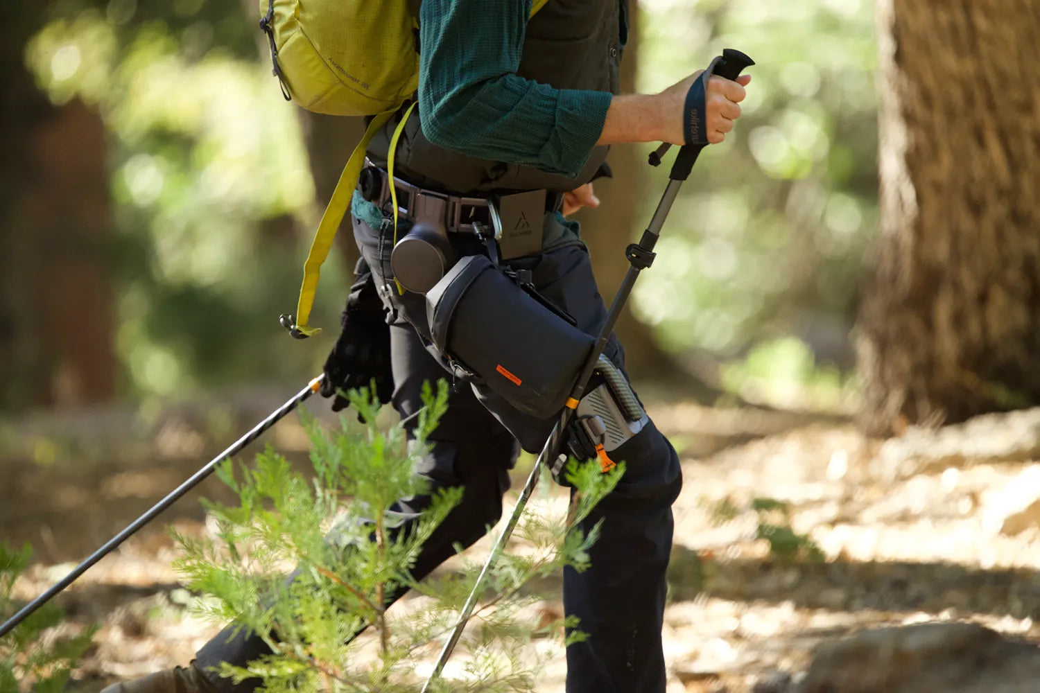 Man wearing Ascentiz knee-assist exoskeleton hiking in the forest
