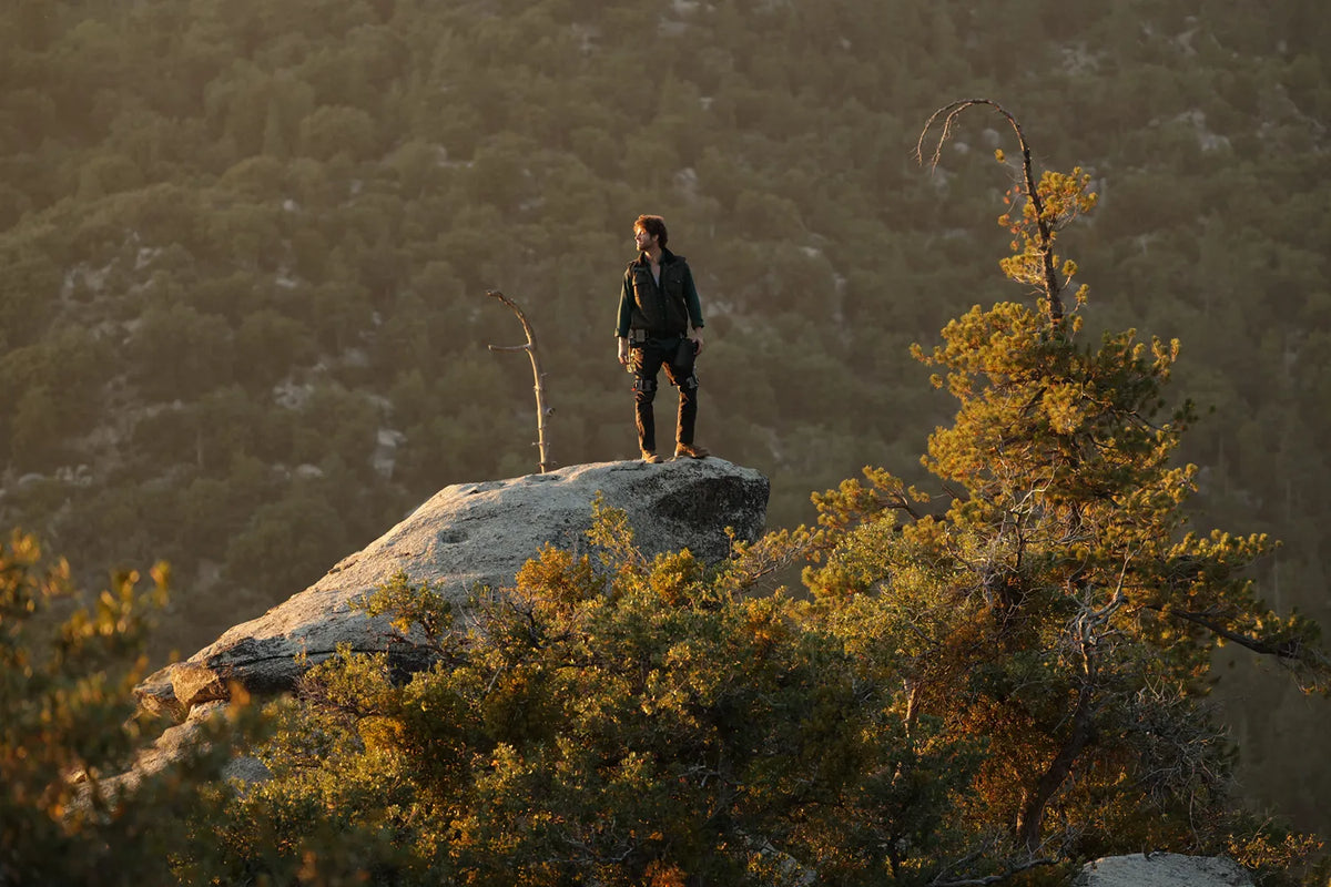 Man standing on rocky peak looking into the distance