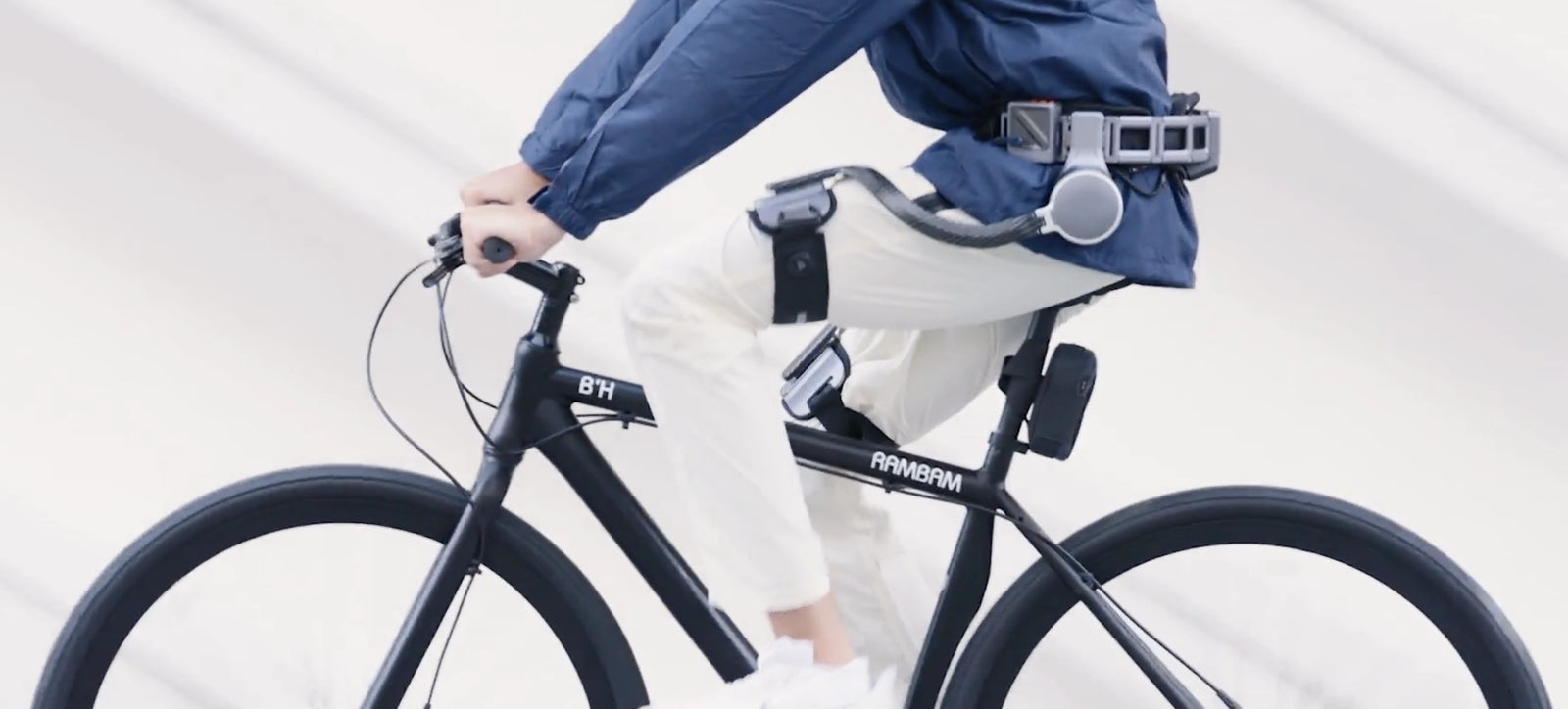 Man cycling through the city,wearing Ascentiz exoskeleton hip kit