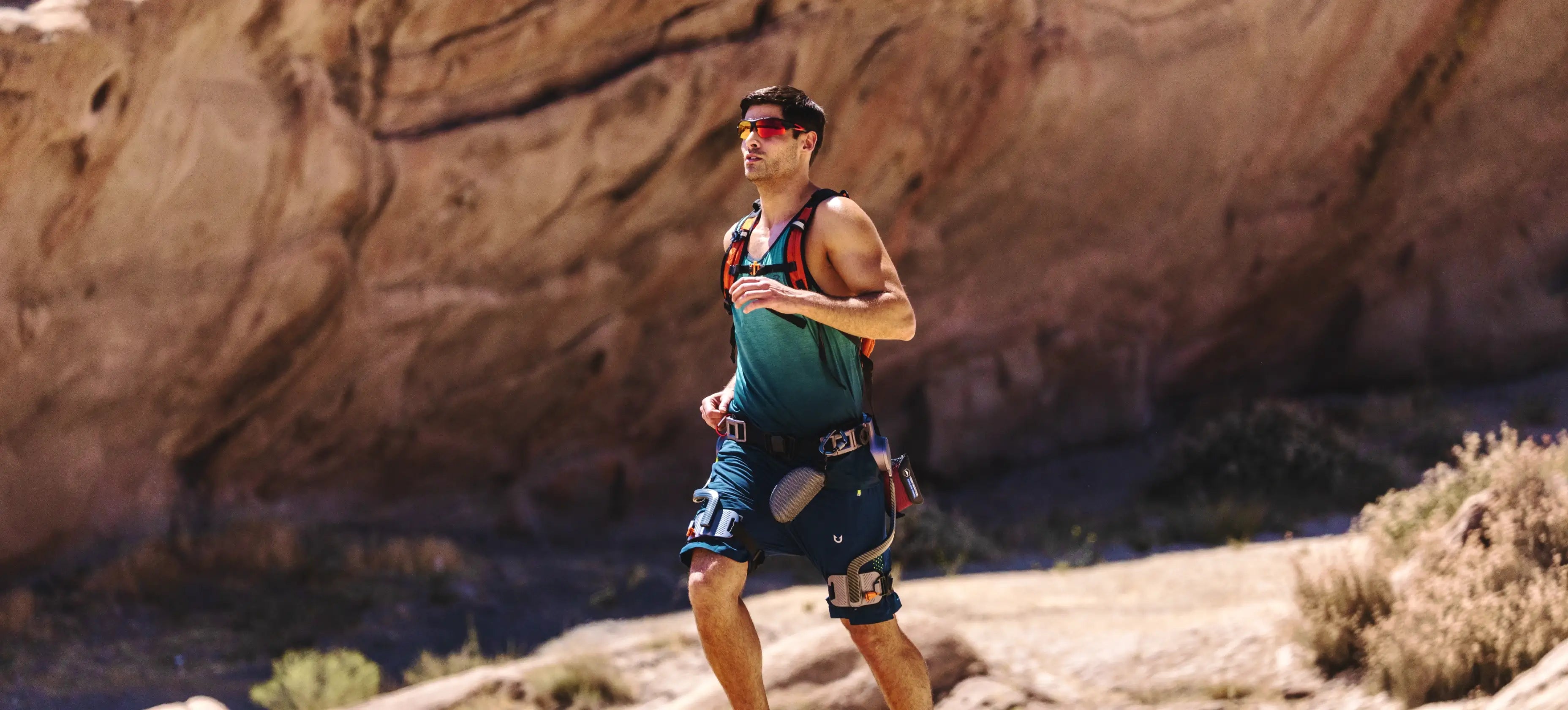 Man running on the trails, wearing Ascentiz exoskeleton hip kit