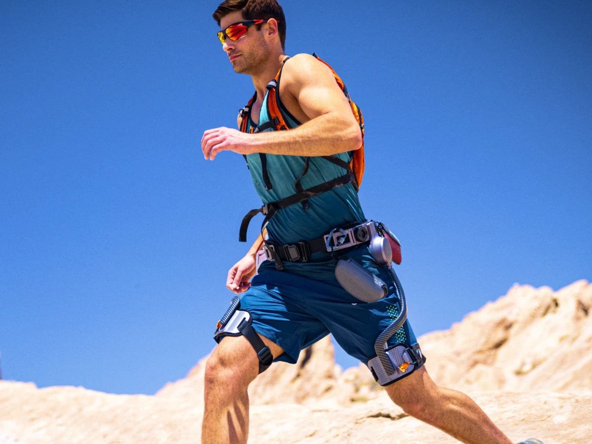 Man running on rocky terrain wearing the Ascentiz Hip Exoskeleton