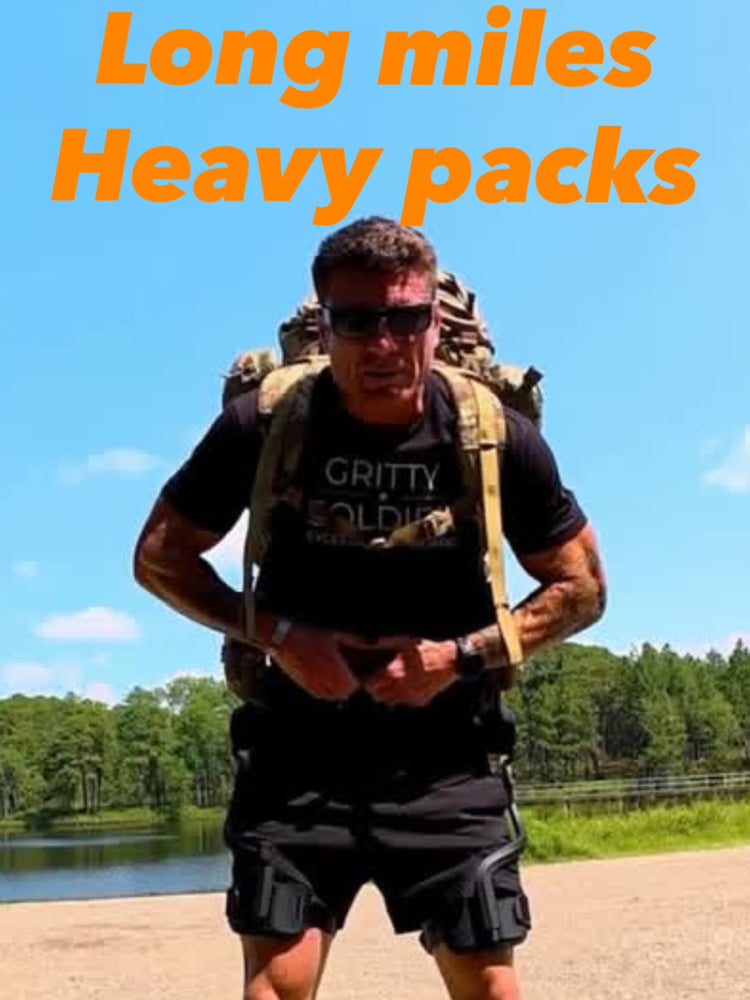 A man carrying a heavy backpack, wearing the Ascentiz hip exoskeleton to support his steps.