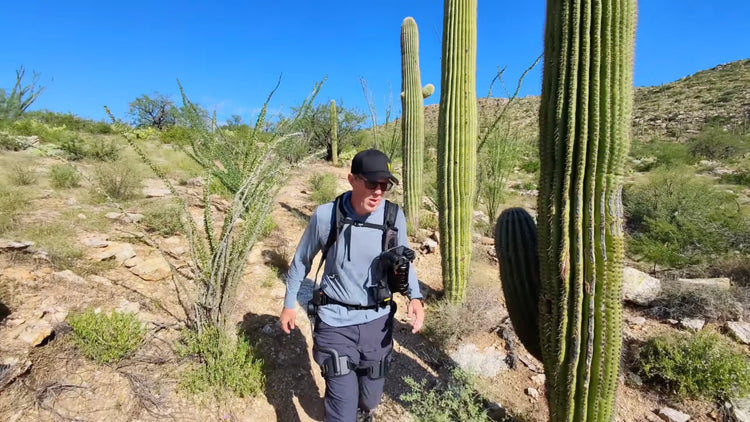 Man walking down a slope route, wearing the Ascentiz H Ultra exoskeleton.
