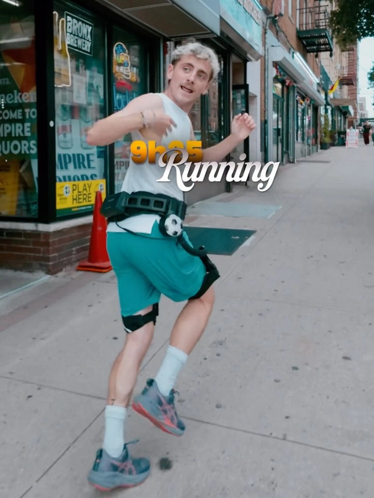A man running on a city sidewalk wearing Ascentiz hip exoskeleton.