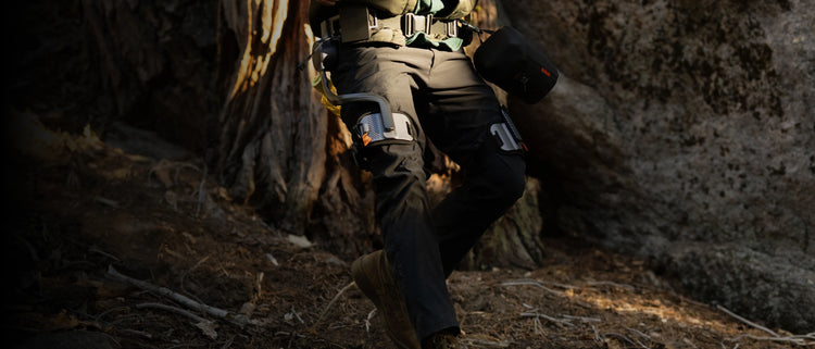 Man running downhill wearing the Ascentiz hip exoskeleton