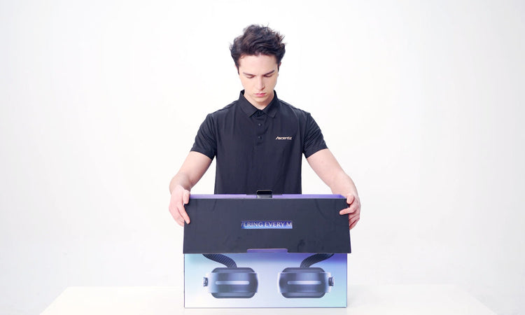 Studio shot of a model demonstrating the unboxing process for the Ascentiz exoskeleton system, opening the branded product packaging box against a white background.