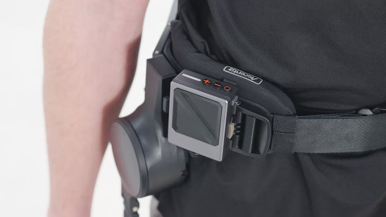 Close-up studio view of the control module on the Ascentiz exoskeleton system, showcasing the LED status indicators and power-on adjustment buttons for the video tutorial thumbnail.
