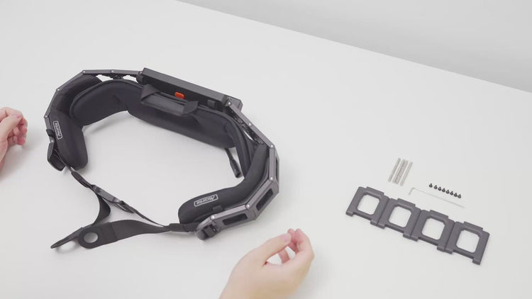 Studio shot demonstrating the hinge assembly process for the Ascentiz exoskeleton system, featuring the joint component and hardware parts laid out on a white surface.