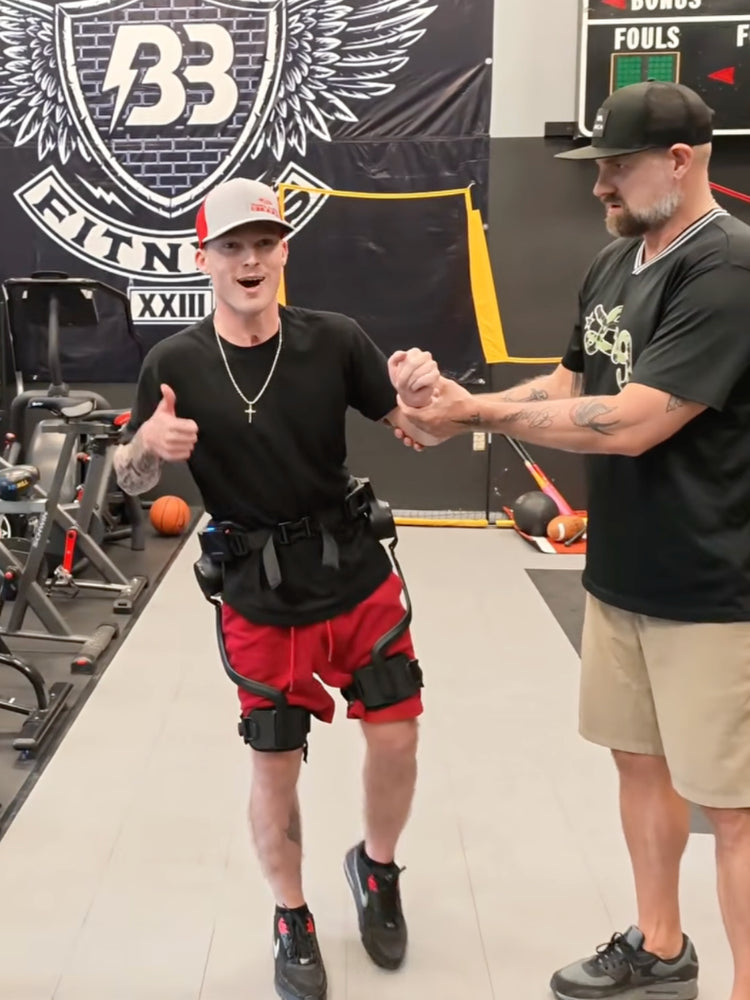 A young man walks with the assistance of Ascentiz hip exoskeleton.